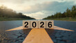 © Art_spiral - 2026 year cubes on road with bold arrow forward concept progress strategy and future direction motivational business vision for banner poster and calendar cover
