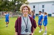 © Rido - Confident female sports coach smile during lesson