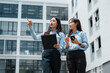 © crizzystudio - Businesswomen discussing real estate property and pointing upwards