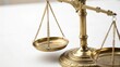 © Farah - Vintage brass scale on white background for legal and justice themes