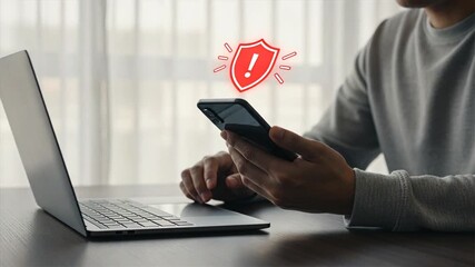 A man holding a smartphone and showing a red scam notification symbol for scam alert warning, fraud alert, email spam issues.