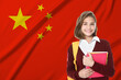 © New Africa - Student with backpack and notebooks against flag of China. Language school