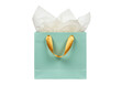 © Matteo - Elegant light blue gift bag with gold ribbon handles isolated, filled with white tissue paper for birthdays and special occasions