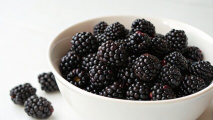 Fresh blackberries in a bowl captured in natural light for culinary use