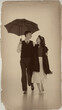 © master1305 - Romantic retro couple walking under umbrella vintage fashion style. Concept of love, lifestyle, emotion, fashion, sepia effect and storytelling editorial.