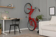 © New Africa - Red bicycle and stylish furniture near grey wall indoors