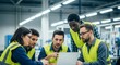 © abdelaziz@771 - Diverse team of engineers collaborating intently on a laptop, strategizing innovation in a modern industrial setting.