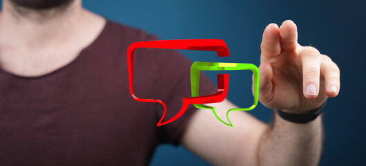 Conceptual image depicting communication. Man touching speech bubble icons, symbolizing digital dialogue, social interaction, and technology con