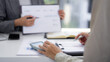 © STBSTD - Asian business professionals collaborate on financial analysis reviewing data charts during an office consultation session for strategic planning