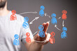 © vegefox.com - A hand interacts with an abstract digital display showing a network of connected people icons, symbolizing social, business, and data connection