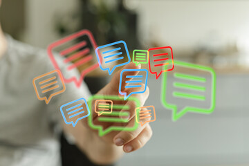 A hand interacts with illuminated message icons, symbolizing digital communication and social networking in the virtual age of technology.