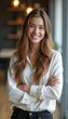 © natakot - Confident young woman smiling with arms crossed