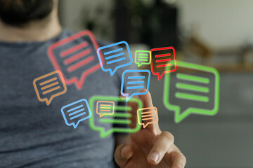 Person touches floating speech bubble icons, symbolizing modern digital communication and social networking interaction online.