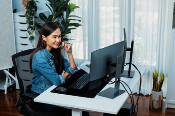Young Asian IT developer looking online information on pc for beautiful pose with coding program data of website application, wearing jeans shirt. surround by safety analysis two screens. Stratagem.