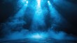 © Verla - Dramatic blue spotlights shining through smoke on a dark stage.