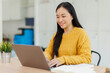 © David - Stylish young asian female freelancer working on laptop while sitting in cozy cafe