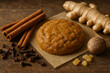 © Freelance - Warm and spicy baked cookie with cinnamon sticks, ginger, and cloves on a wooden table