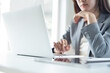 © tippapatt - Young smart business woman working, using laptop computer  remote working from home office. Businesswoman searching the inforamtion, surfing the internet on laptop, online job, e-business