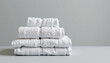 © Cherrin - White towel stack soft cotton bath linen folded neatly for home spa comfort