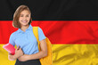 © New Africa - Happy student with backpack and notebook against flag of Germany. Language school