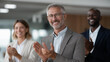 © Vitalii - Senior leaders recognizing and rewarding employees for outstanding performance at a workplace celebration, highlighting professional growth, diversity, motivation, talent retention, workplace