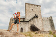 © EdNurg - Happy tourist holding Serbian flag visiting the medieval fortress on top of a hill near Vrsac in Serbia