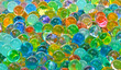 © Levon - A bunch of colorful marbles are scattered on a surface