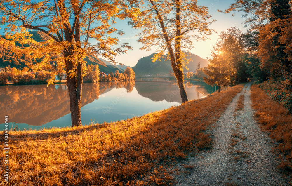 Scenic autumn view of a river with mountains reflected in calm water ...