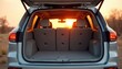 © miss irine - Car trunk open at sunset in a dry landscape. Vehicle is clean and empty, suggesting travel preparation or arrival. Sun shines warmly through rear window.