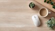 © Bath - A minimalist workspace featuring a white wireless mouse, a cup of coffee, and small potted succulents on a light wood desk
