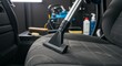 © AbdulBasit - Car interior dry cleaning using a vacuum cleaner for thorough detailing.