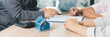 © doidam10 - Panorama view of business meeting with miniature house model on desk, real estate contract signing, property investment, mortgage loan agreement and financial planning concept. mortgage loan agreement