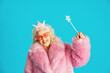 © oneinchpunch - Beautiful senior old woman wearing fancy party clothes acting on a colored background in studio
