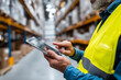 © Anastasiia Havelia - Warehouse worker using digital tablet to control smart logistics system, bright industrial background,