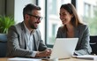 © wang - Two busy happy professional business man and woman executive leaders team using laptop working on computer at work desk having conversation on financial project at meeting in office. High quality
