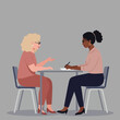 © talkative.studio - Two women in professional attire sit at a table, one speaking, the other writing