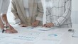 © rogerphoto - Professional team reviewing financial data, jointly analyzing charts and graphs in modern office, pointing at statistics during strategic planning. Business people concept