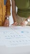© rogerphoto - Business professionals analyzing financial reports, pointing at charts during collaborative meeting, discussing data with focused professional demeanor