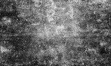 A high-contrast, black and white abstract grunge texture background featuring a distressed surface with heavy grain, spots, and scratches, ideal as a vintage overlay or dark, moody backdrop.
