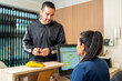 © Guillermo Spelucin - Client checking in at physical therapy center reception