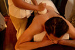 © InfiniteFlow - Hot herbal ball spa massage body treatment, masseur gently compresses herb bag on man body. Tranquil and serenity of aromatherapy recreation in warm lighting of candles at spa salon. Quiescent