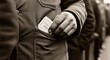 © photoplotnikov - African male hand holding ration ticket in pocket