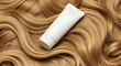 © MilioDerestd.co - Hair care product on golden wavy hair, beauty and treatment concept.