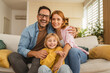 © Miljan Živković - Parents and daughter smiling at home together
