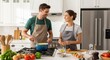© AFFANYUDA - Couple cooking together in kitchen