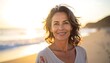 © Nice - Smiling woman on beach at sunset