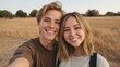 © 69 - Happy young couple enjoying a sunny day outdoors in a golden field, smiling at the camera with a carefree atmosphere and beautiful sunset backdrop