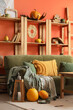 © Pixel-Shot - Interior of stylish living room with green sofa, shelf unit and pumpkins