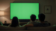 © Rendy Haris - A Blank TV Screen Mockup with a Family Watching on New Year's Eve