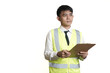 © yashis007 - Professional male supervisor in a high-visibility vest meticulously checking a list on his clipboard during a workplace inspection